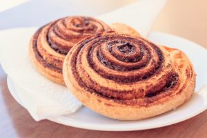 Freshly baked cinnamon rolls on a plate.