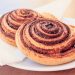Freshly baked cinnamon rolls on a plate.