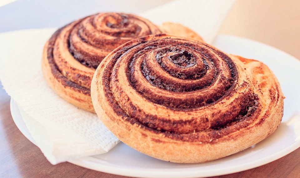 Freshly baked cinnamon rolls on a plate.