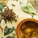 Cloves and bay leaves with curry powder in a wooden bowl.