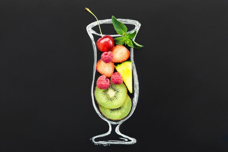 Mixed fruit smoothie in a glass outline with cherries, strawberries, and kiwi slices.