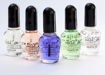 Bottles of Haken cuticle oil in various colors arranged in a row.