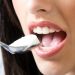 Eating yogurt with a spoon, close-up view.