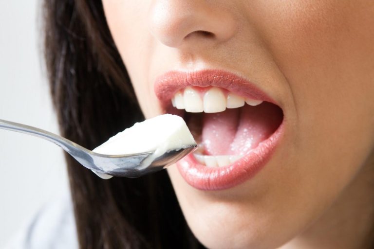 Eating yogurt with a spoon, close-up view.