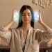Calm woman meditating with hands aura.