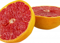 Half pink grapefruit with juicy flesh.