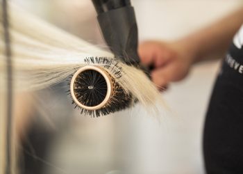 Hair styling with round brush and blow dryer.