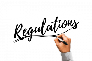 Hand writing Regulations with black marker.