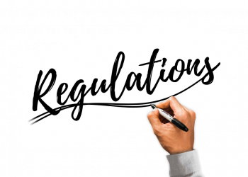Hand writing Regulations with black marker.