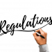 Hand writing Regulations with black marker.