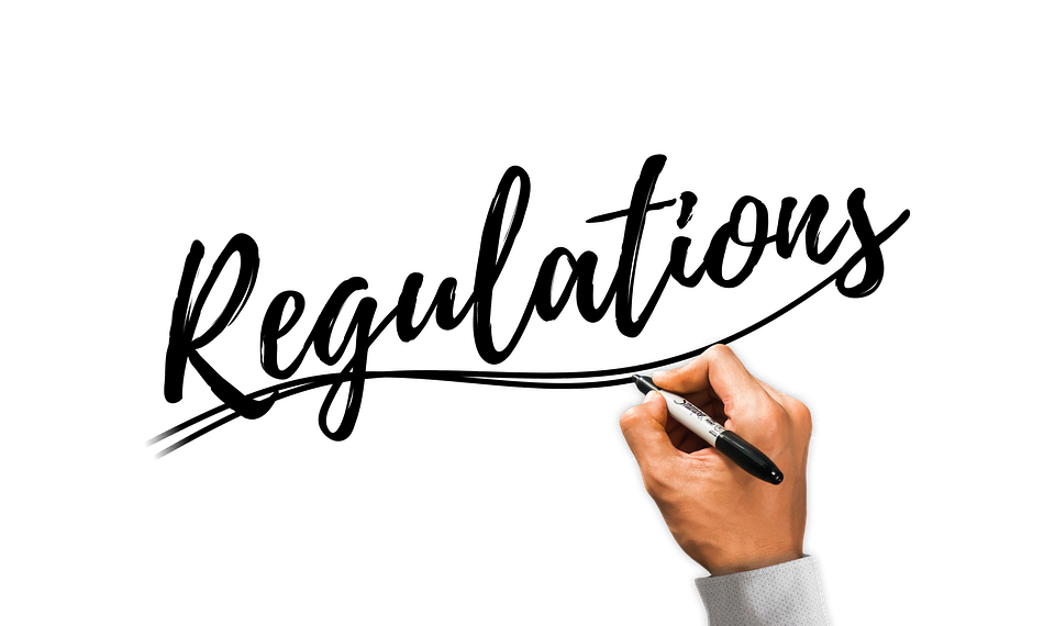 Hand writing Regulations with black marker.