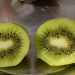Sliced fresh kiwi revealing seeds and green flesh.