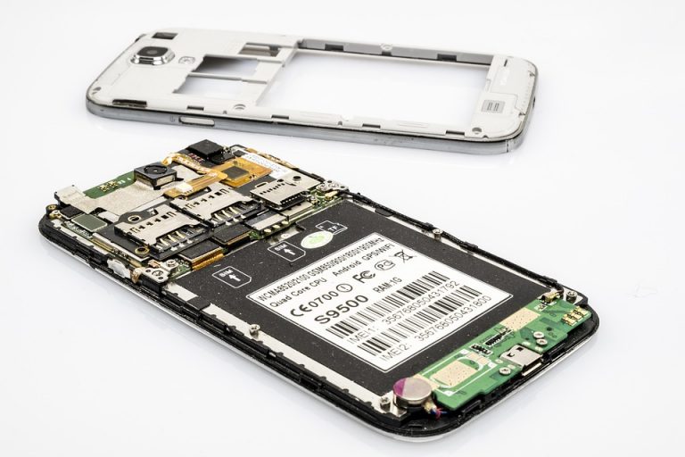 Disassembled smartphone showing internal components and circuit board.