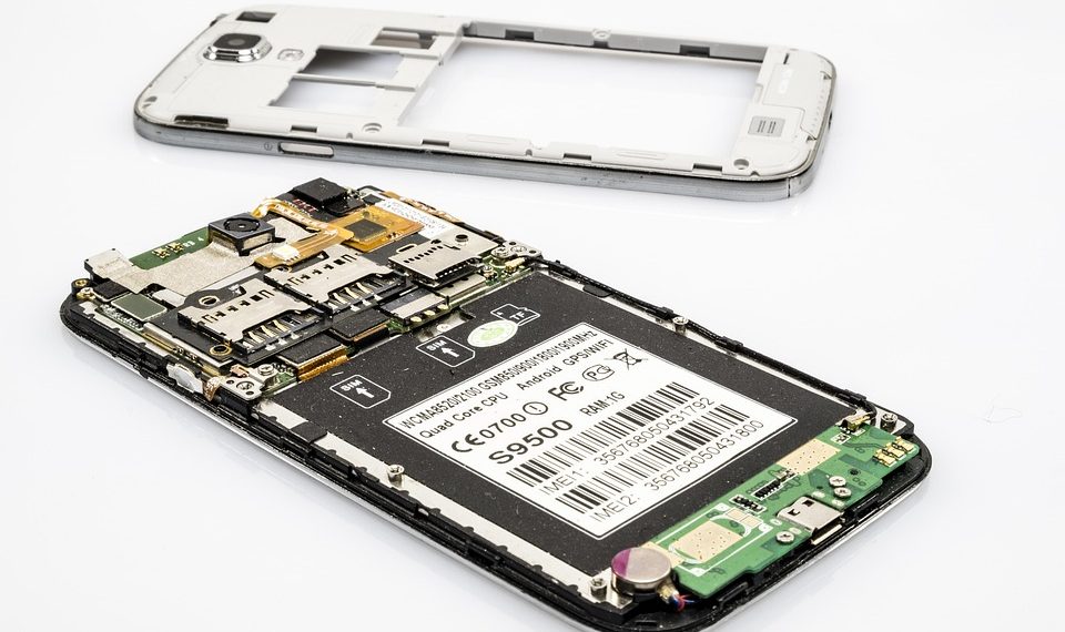 Disassembled smartphone showing internal components and circuit board.