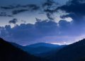 Mountain landscape at twilight with dramatic clouds.