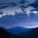 Mountain landscape at twilight with dramatic clouds.