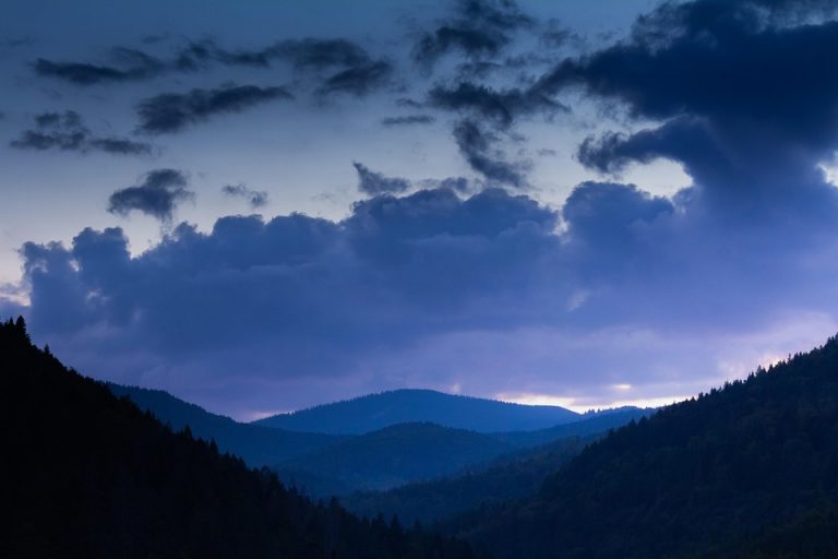Mountain landscape at twilight with dramatic clouds.