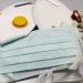 N95 and surgical face masks on table.