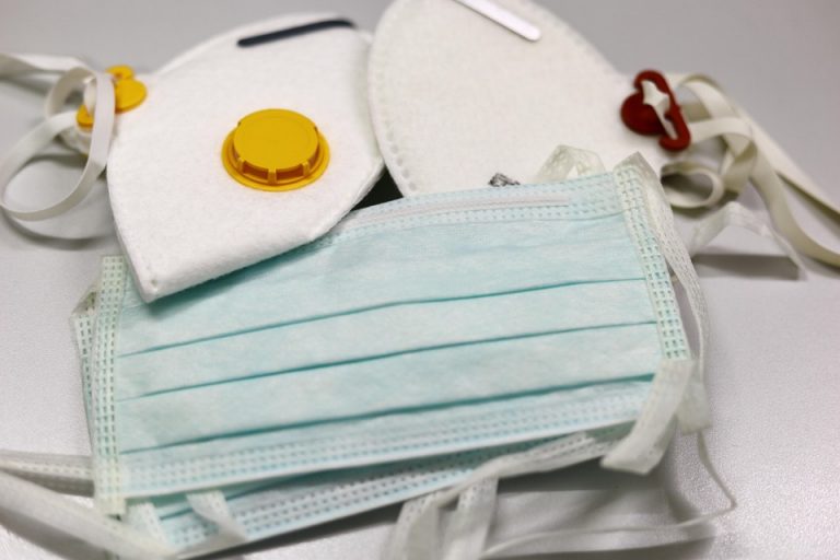 N95 and surgical face masks on table.