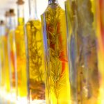 Bottles of infused olive oil with herbs and spices.