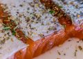 Seasoned salmon fillet with herbs and spices.