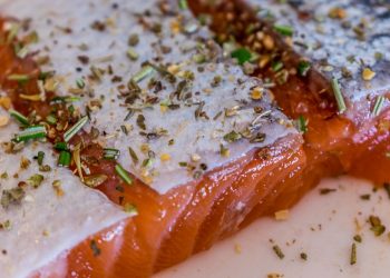 Seasoned salmon fillet with herbs and spices.