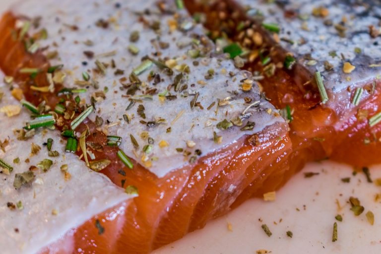 Seasoned salmon fillet with herbs and spices.