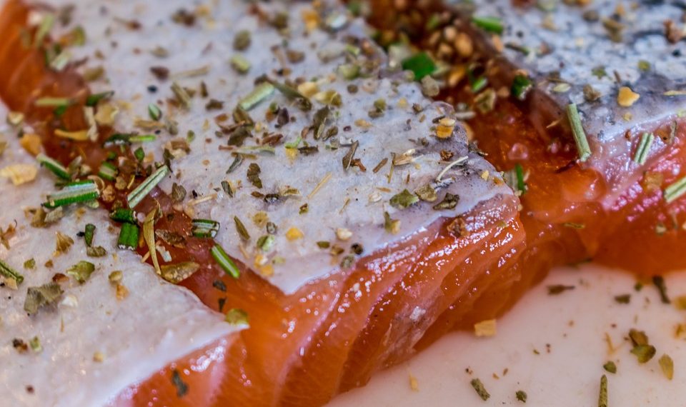 Seasoned salmon fillet with herbs and spices.