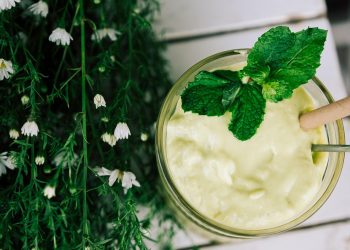 Creamy avocado smoothie garnished with fresh mint leaves.