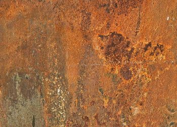 Rusty metal surface texture with orange and brown tones.
