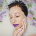 Woman with floral decorations relaxing in milk bath.