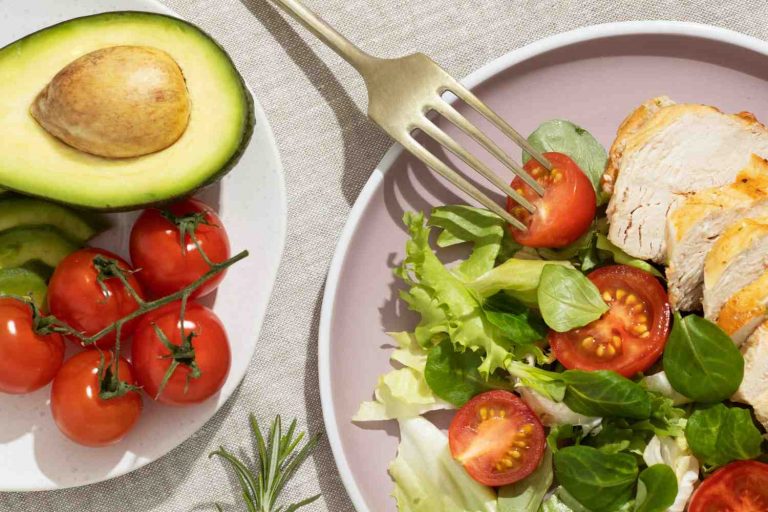 Avocado, tomatoes, and salad with grilled chicken.
