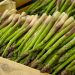 Fresh asparagus spears stacked in a crate.
