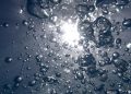 Bubbles rising underwater with sunlight filtering through.