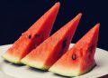 Three watermelon slices on a plate.