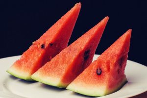 Three watermelon slices on a plate.