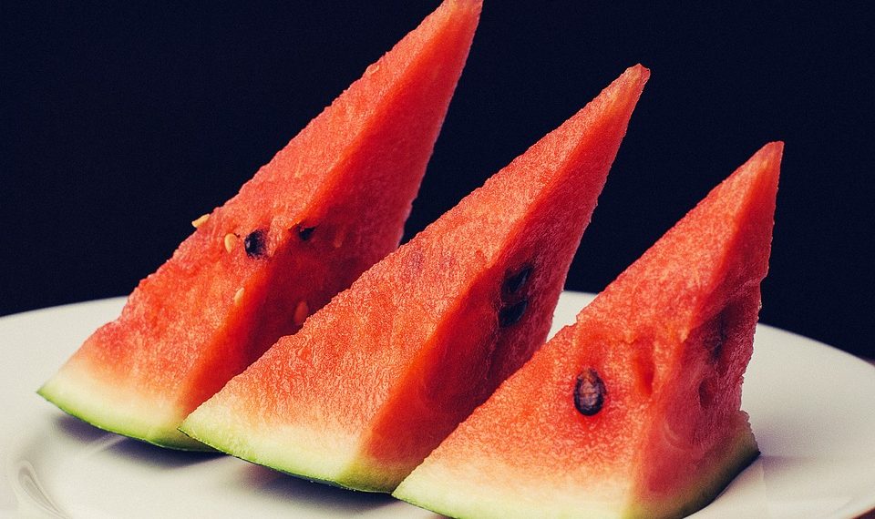 Three watermelon slices on a plate.