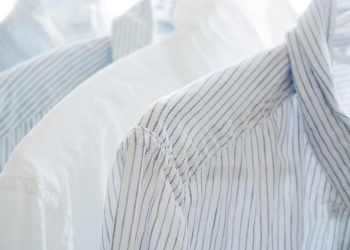 White and blue striped shirts on hangers.