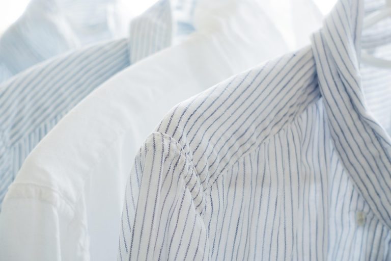 White and blue striped shirts on hangers.