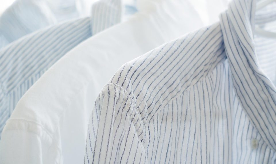 White and blue striped shirts on hangers.