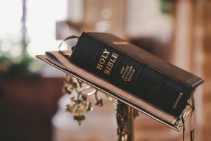 Holy Bible on a lectern in church setting.