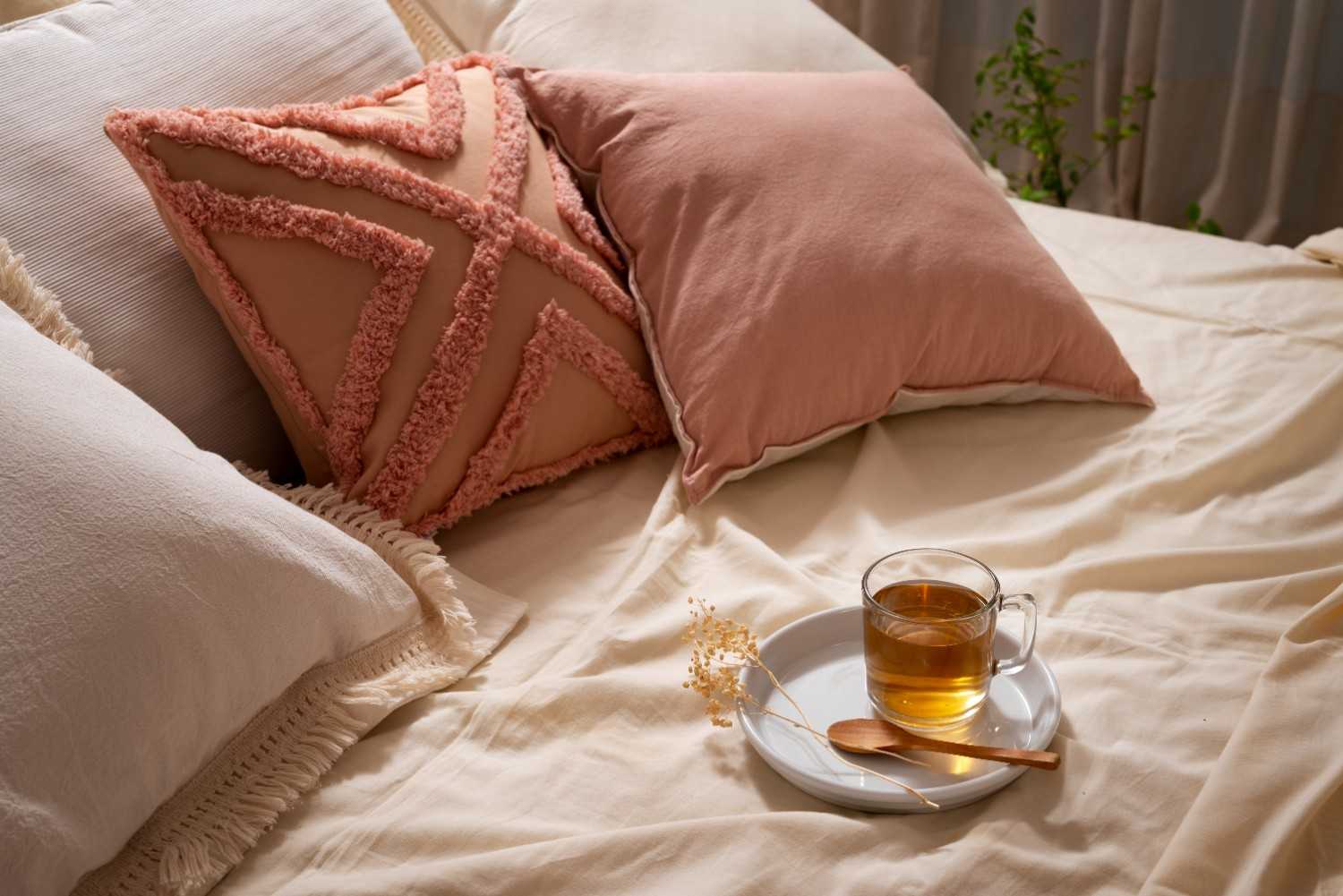 High angle cozy bed arrangement with tea