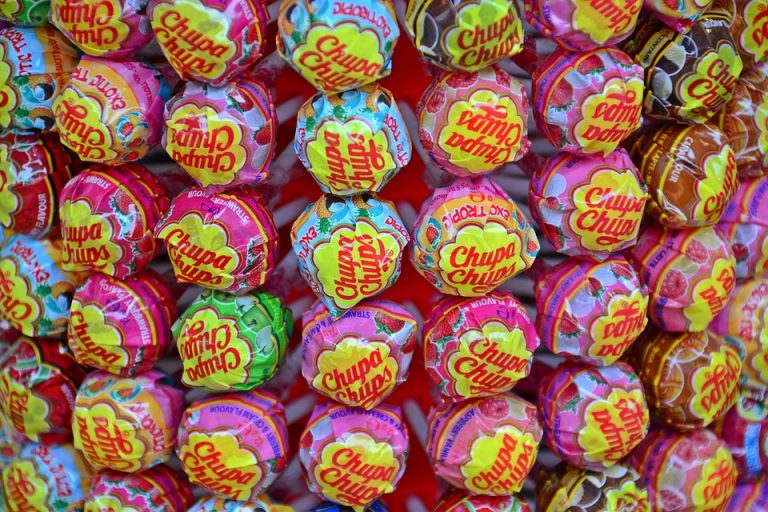 Colorful Chupa Chups lollipops displayed in neat rows, showcasing various flavors.