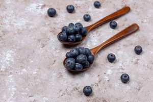 bilberry Natural blueberries on light brown surface