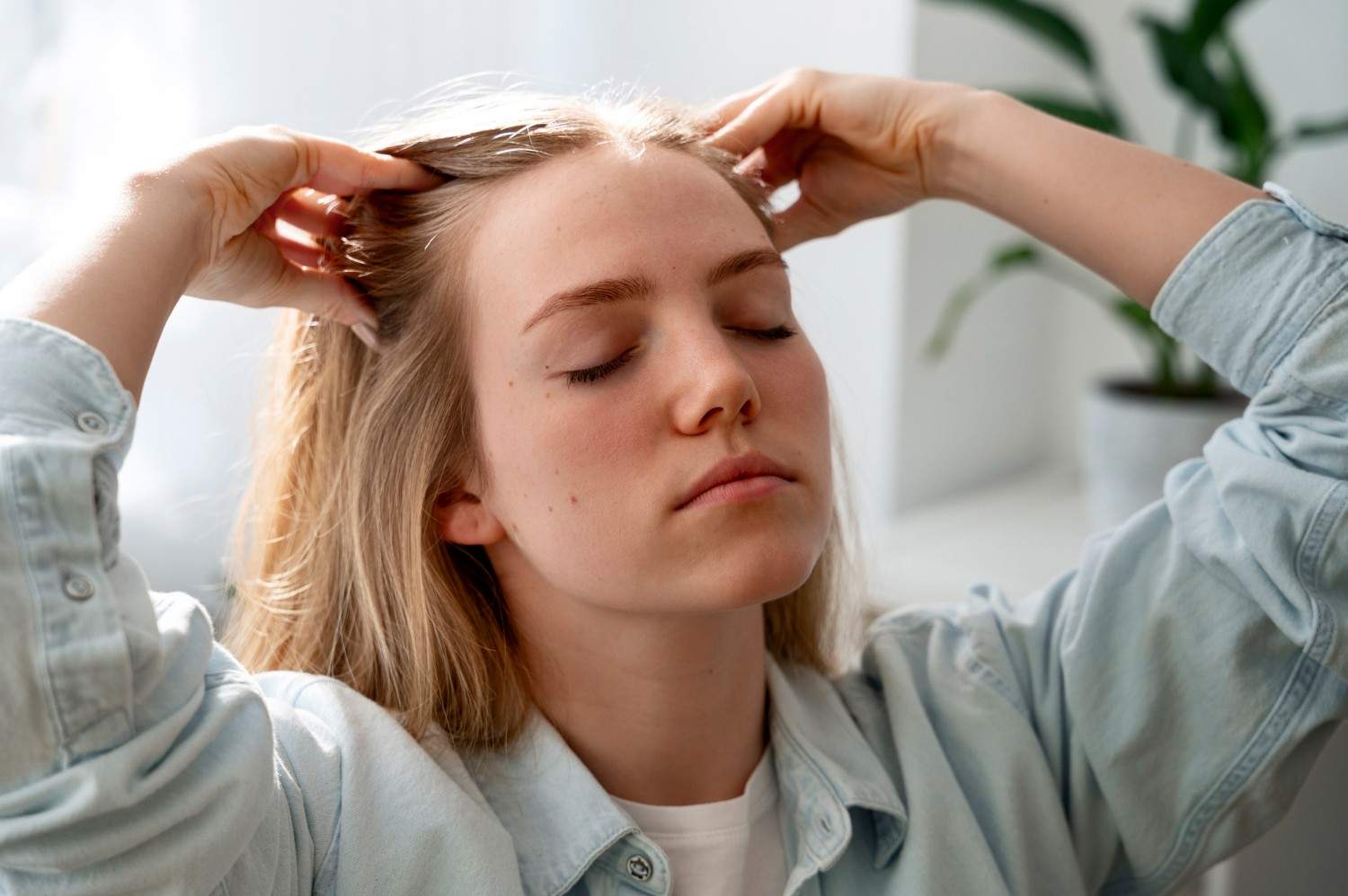 Woman giving herself scalp massage