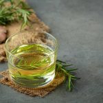 Oil with rosemary on table
