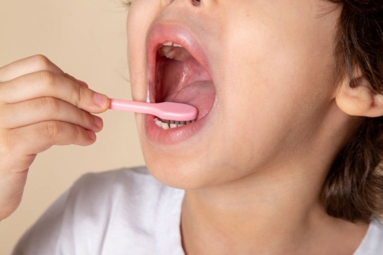 Close up, view little boy cleaning his teeth
