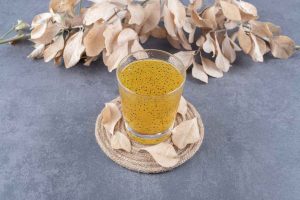 Freshly made tangerine juice on grey background.