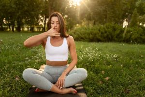 Front view woman meditating on mat