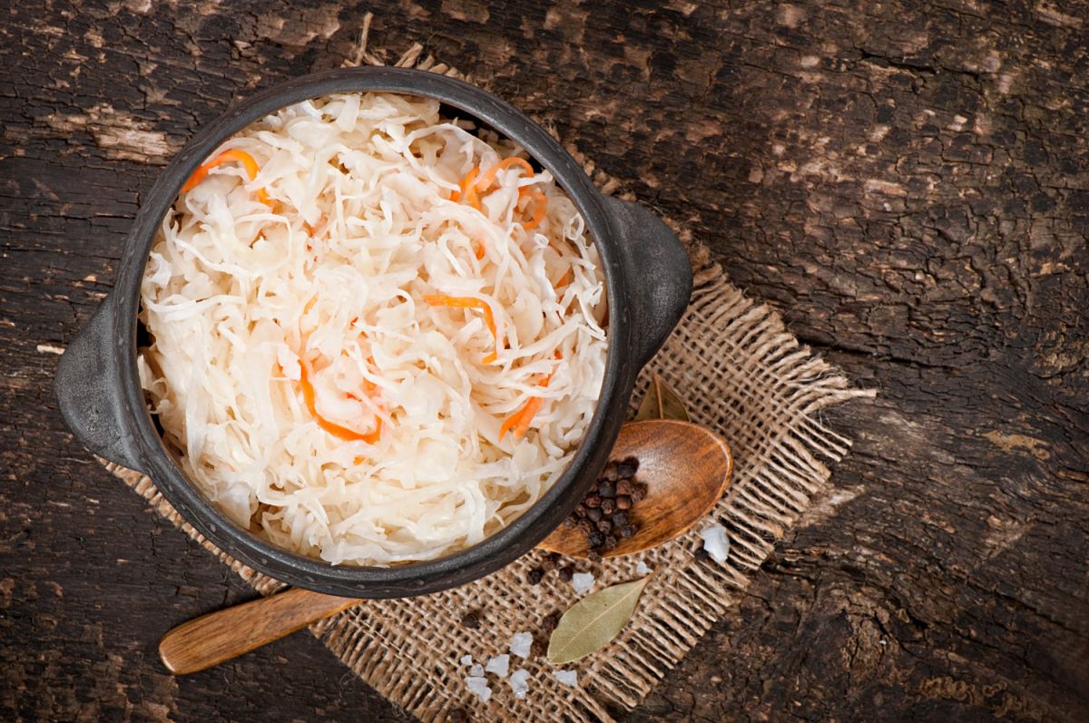 Sauerkraut with carrot in wooden bowl